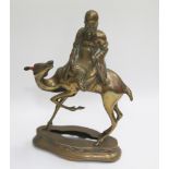 Oriental brass model of an elderly sage seated on the back of a deer like animal on a shaped base