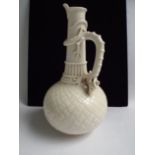 Large Belleek style basket weave porcelain ewer with dragon handle. Indistinct brown printed marks