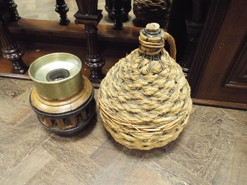 Wagon wheel hub spittoon and a wicker covered cider jar