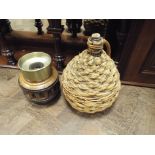 Wagon wheel hub spittoon and a wicker covered cider jar