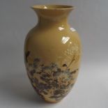 Japanese pottery vase decorated with birds amongst foliage, on a buff ground, impressed circular