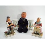 Pair of Staffordshire seated pottery figures of an elderly lady and gentleman;