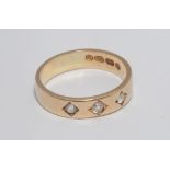 18ct yellow gold gypsy style band ring, set with three diamonds, ring size Q, weight 5.7 grams.