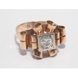 1950's rose gold cocktail ring, set with a solitaire diamond, in scrolled stylised mount.