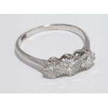 Three stone diamond ring set with graduated brilliant cut diamonds,