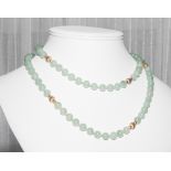 Long jade bead necklace, with gold spacer beads.