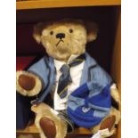 Teddy bear dressed as a school boy