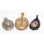 Two oval pinchbeck pendants, one with enamel cross and the other with memorial inscription,