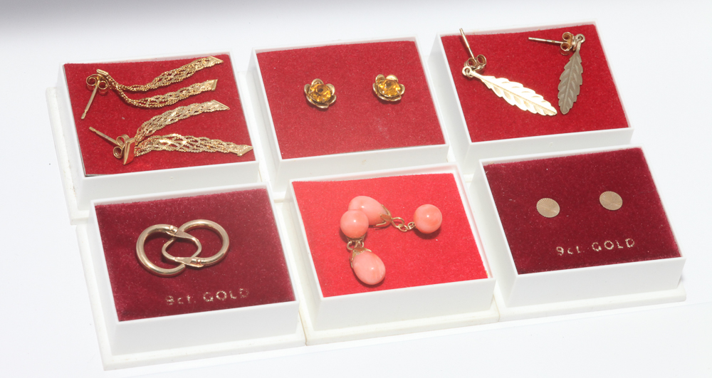 Six pairs of gold earrings to include coral drops. all with pierced fittings.