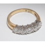 Five stone diamond ring, set with 5 uniform brilliant cut diamonds in a half hoop setting,