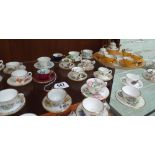 Collection of 43 miniature bone china cups and saucers by Spode, Wedgwood,