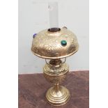 Victorian brass oil lamp with embossed decoration,