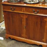 Modern mahogany and yew wood side cabinet,