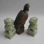 Carved soapstone model of a bird 15.5cm high and a pair of carved dog of fo's each 9.