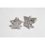 Pair of modern diamond set star design pierced earrings, in white metal , tests as 18 ct gold  1