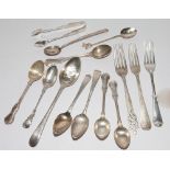 Odd silver spoons and flatware and a pair of sugar nips,