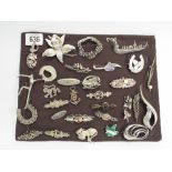 Collection of silver Brooches mounted on a card - approximately 30,