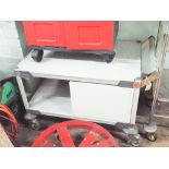 Grey metal and plastic service trolley with cupboard and good quality castor wheels