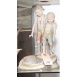 Dux style figure ornament of two young boys