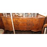 5' 1950's reproduction figured walnut shaped front sideboard with fitted centre drawer standing on