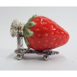 Novelty porcelain strawberry fruit scent bottle with white metal mount and stand.