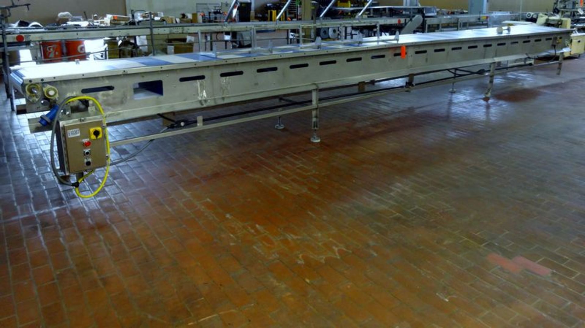 E-Quip plastic belt conveyor. Approximate 24" wide x 30' long. Stainless steel frame, no motor.