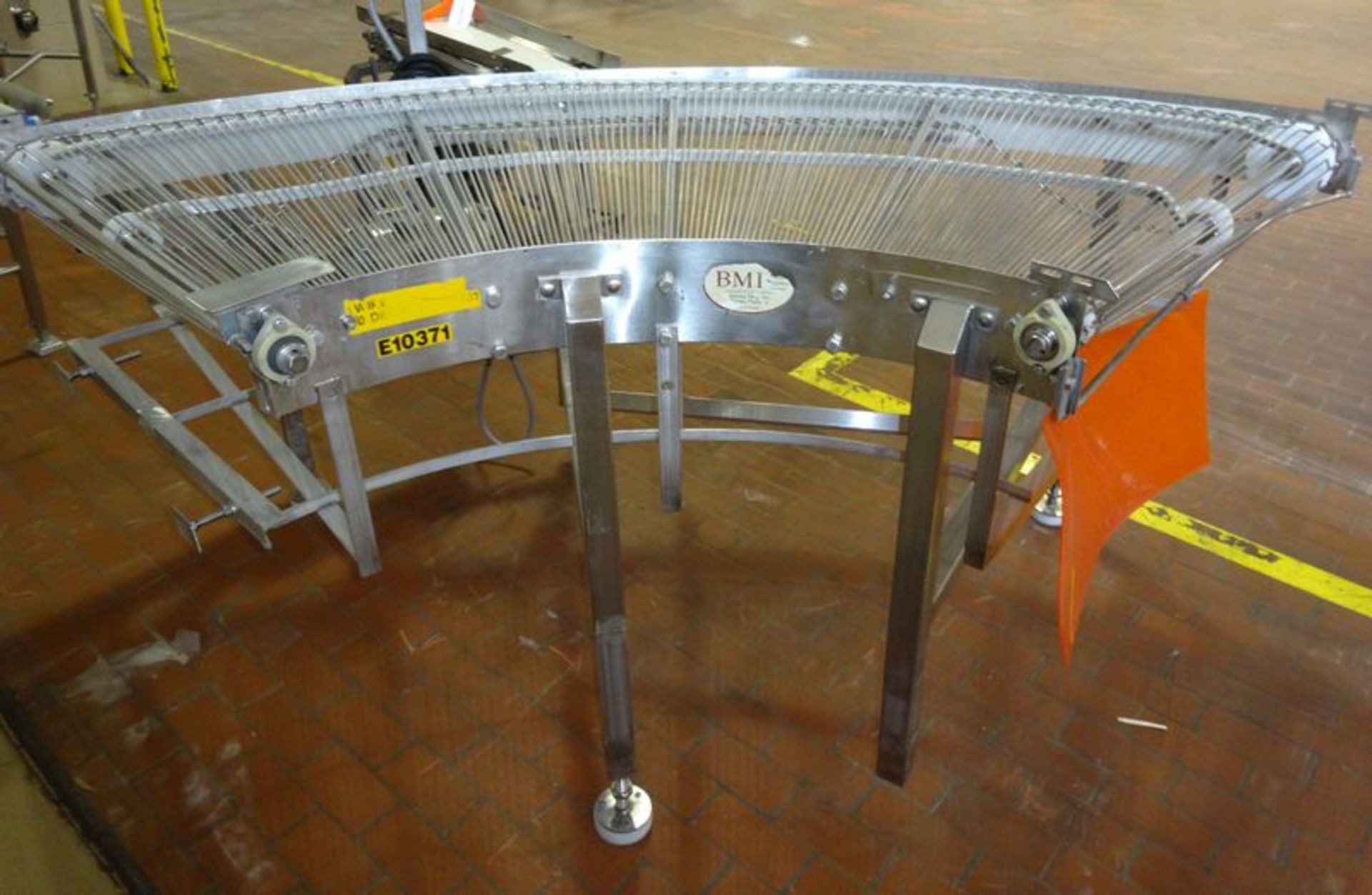 BMI mesh belt conveyor. 44" wide 90 degree turn. With motor, stainless steel frame..