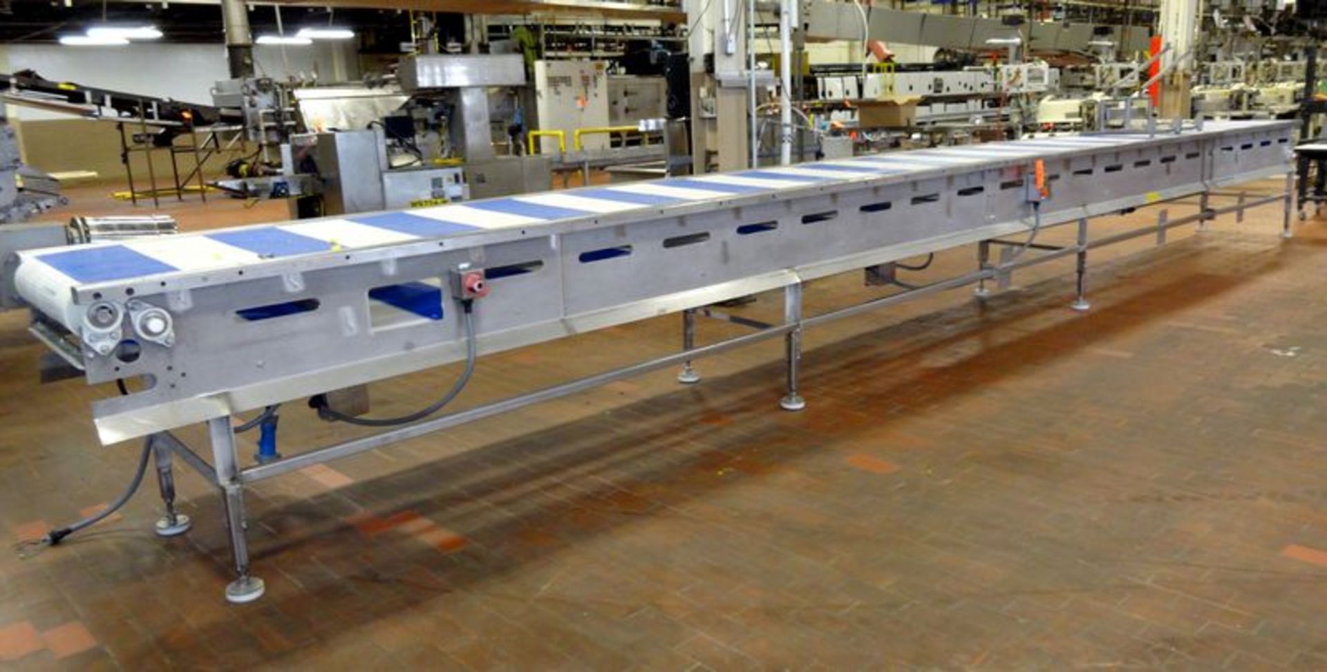 E-Quip plastic belt conveyor. Approximate 24" wide x 30' long. Stainless steel frame with motor.