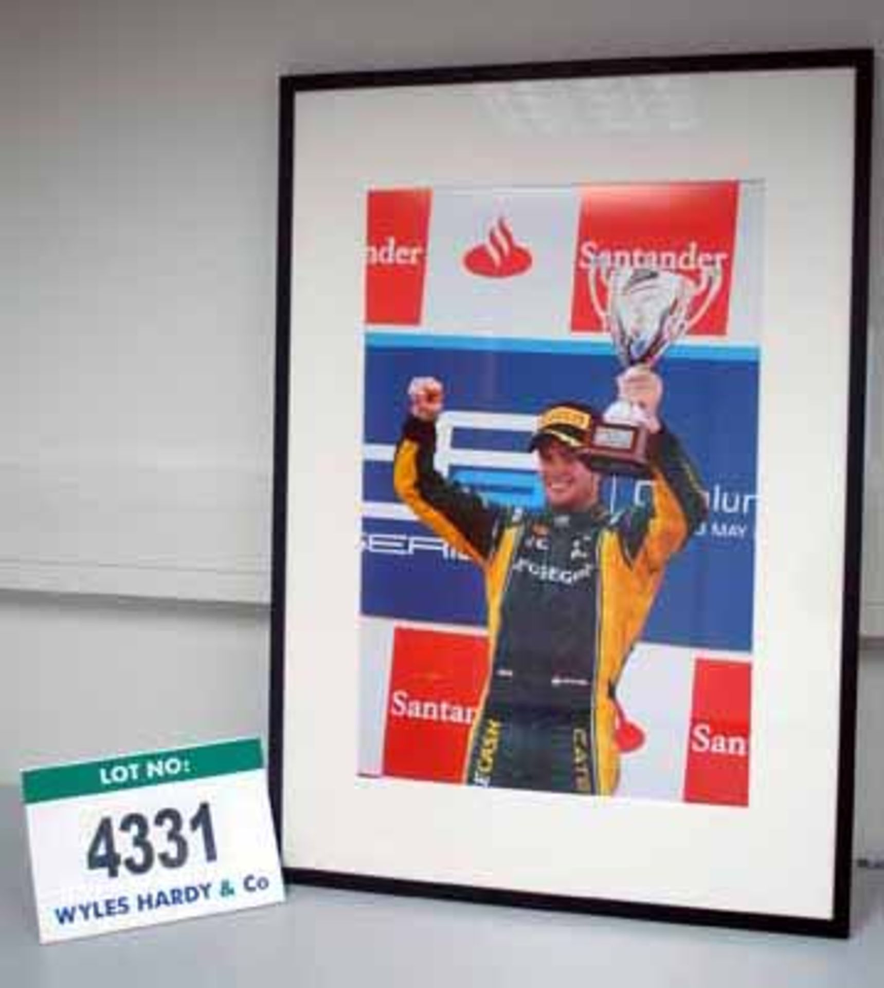 A 700mm x 900mm Framed and Glazed Photograph of Giedo Van Der Garde holding the GP2 Trophy -