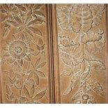 A pair of panels, carved hollyhocks, clematis and other flowers, 153 x 19 cm (2)