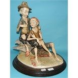 A pottery group, of two gentlemen on a beach, on a wooden base, 45 cm high
