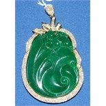 A carved green hardstone pendant, in a yellow coloured metal mount, set diamonds