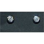 A pair of 9ct white gold and diamond stud earrings, with a Solitaire Gemmological Laboratory