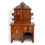 A Bombay style Arts & Crafts type cabinet, with inlaid decoration, the superstructure having a panel