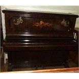 A John Spencer & Co upright piano, in an inlaid case, with brass sconces, 141 cm wide, and an