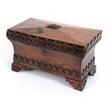 A Victorian rosewood tea caddy, of sarcophagus form, with Gothic style carved decoration, 33 cm wide