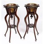 A pair of walnut jardiniere stands, with brass liners, 93.5 cm high (2)  See illustration