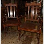 A pair of oak carver chairs, with solid seats (2)