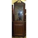 A floor standing corner cupboard, having a bar glazed door above a panel door, 74 cm wide