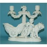 A Continental porcelain candelabrum group, of a chariot, cherub and lion (a.f.), 24 cm high