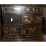 A Japanese black lacquer table top cabinet, decorated birds and foliage, 71 cm wide