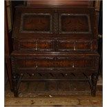 A carved oak bureau on stand, 97 cm wide