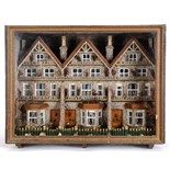 An unusual Victorian diorama, in the form of three terraced houses, with shell and other decoration,