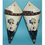 A pair of pottery wall pockets, decorated ladies, 31.5 cm high (2)