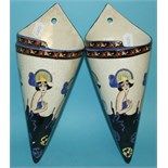 A pair of pottery wall pockets, decorated ladies, 31.5 cm high (2)