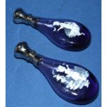 A pair of glass scent bottles, with Mary