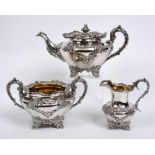 A Victorian silver three piece tea service, decorated flowers and foliage, James Nasmyth & Co,