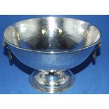 A silver pedestal bowl, with lion mask ring handles and hammered decoration, London 1927, approx.