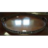 An oval mahogany tray, with a pierced ga