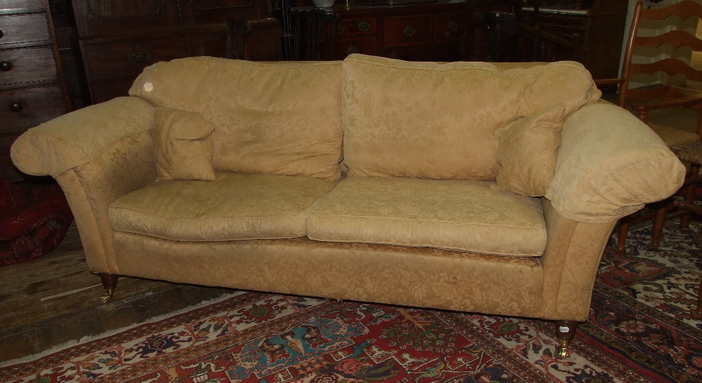 An upholstered three seater settee, with